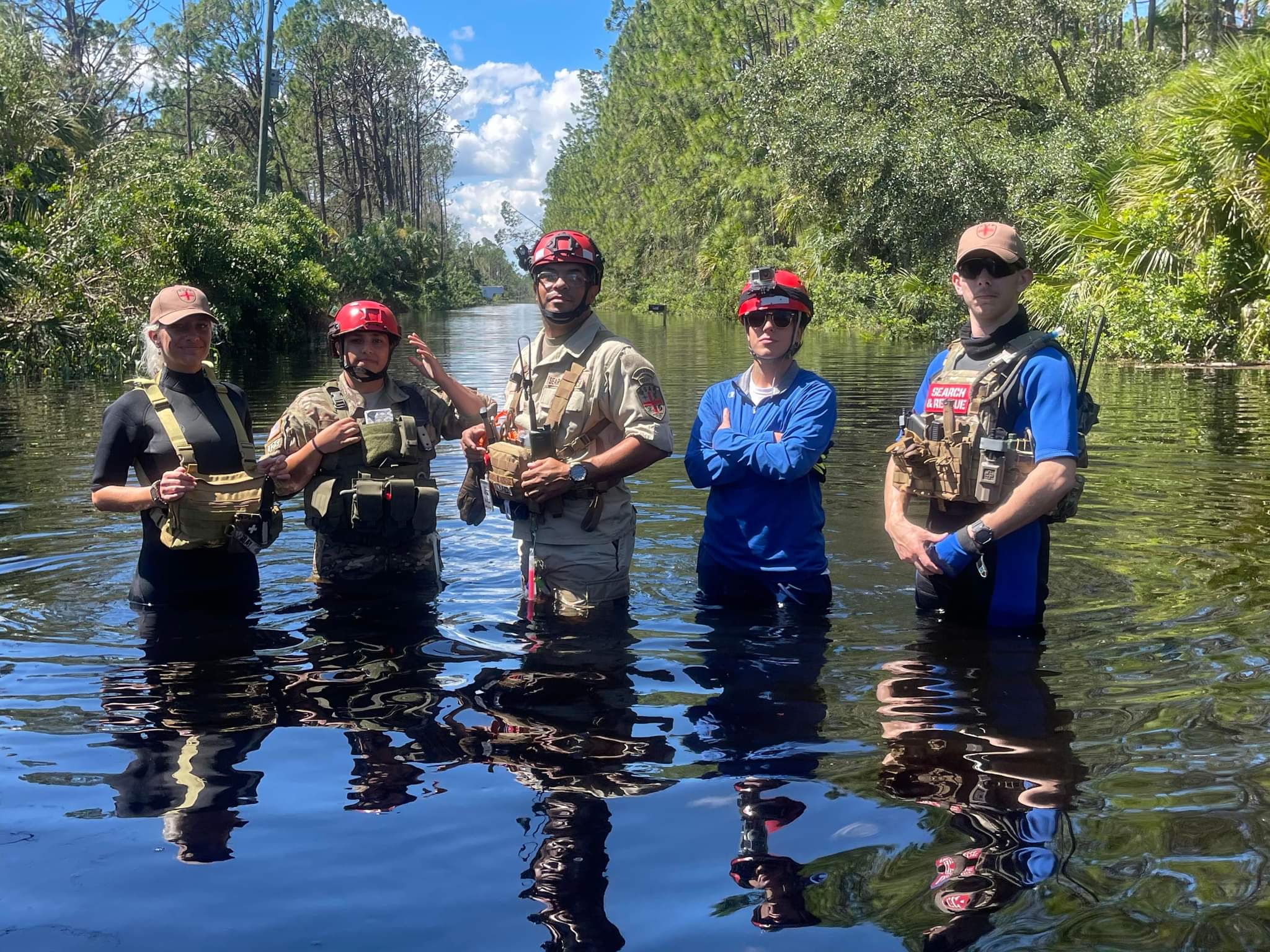 HelpNow search and rescue team standing in floodwater during a deployment